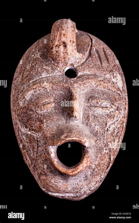 An Ancient Terracotta Vase Or Jug Shaped Like A Human Face Isolated