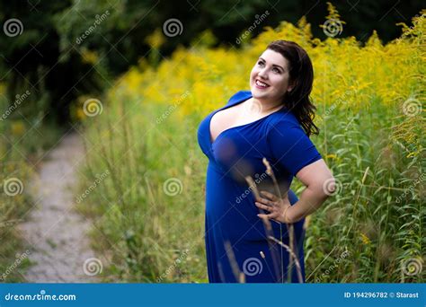 Happy Plus Size Fashion Model In Blue Dress With A Deep Neckline Outdoors Beautiful Fat Woman