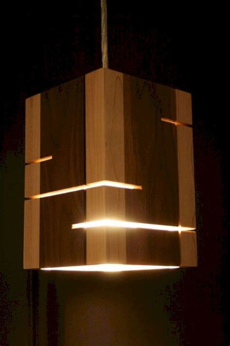 A Wooden Light Fixture Hanging From The Ceiling In A Dark Room With No