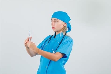 Free Photo Female Doctor Holding Syringe For Injection In Blue Uniform