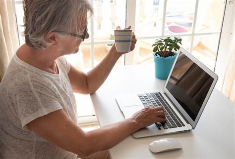 Premium Photo Side View Of Senior Woman Using Laptop At Home