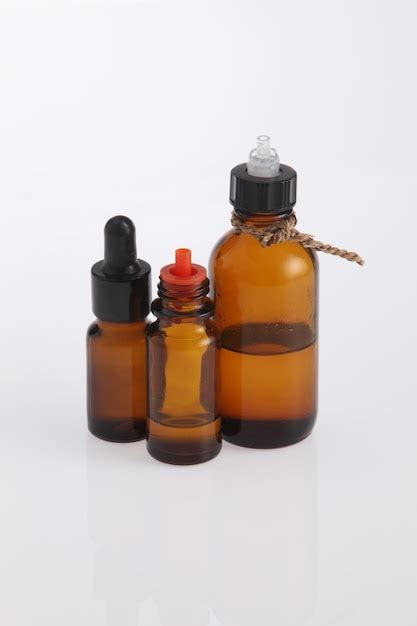 Premium Photo Massage Oil In Bottles Against White Background