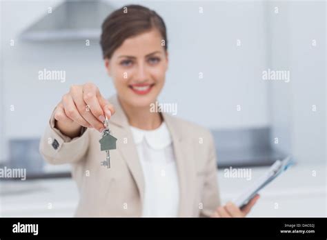 Pretty Real Estate Agent Giving House Key Stock Photo Alamy