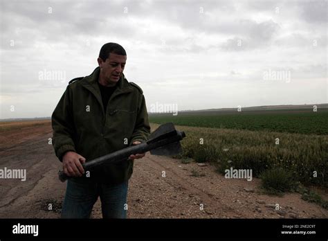 A Sderot Security Officer Examines The Remains Of A Rocket Fired From