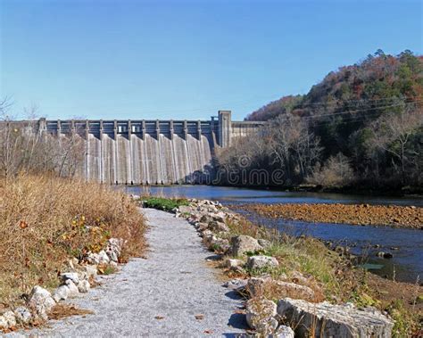 Old Rural Hydroelectric Dam By A River Surrounded By Thick Trees Stock