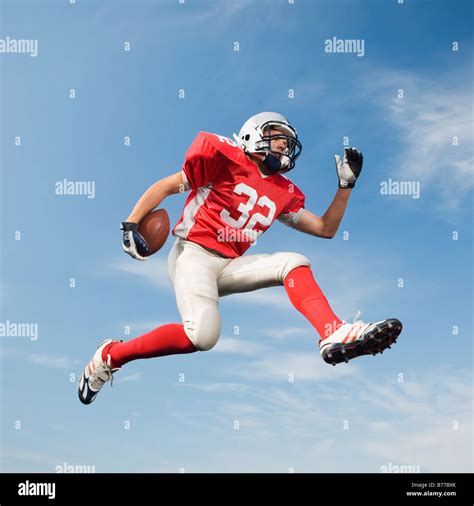 Football Player Mid Air Holding Football Stock Photo Alamy