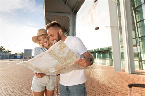 Premium Photo Excited Couple Using Map Planning Route For Vacations