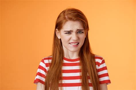 Premium Photo Cute Disgusted Redhead Girl Cringe From Aversion Bad