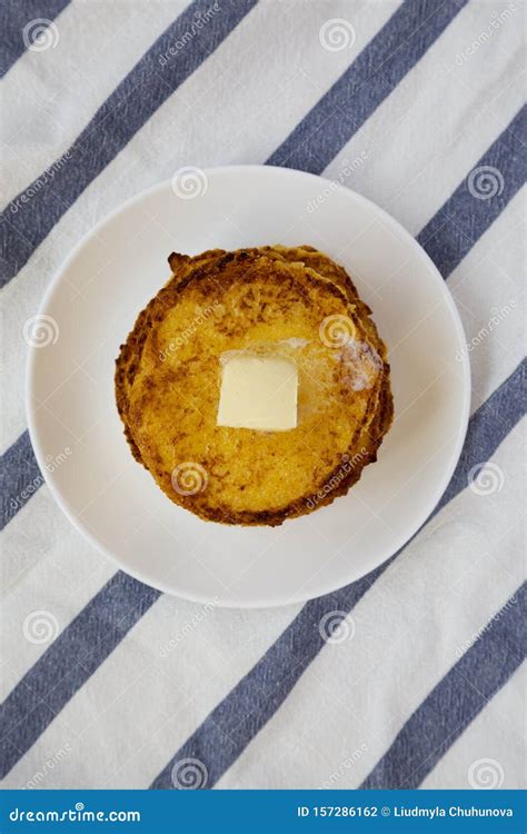 Homemade Corn Meal Johnny Cakes With Butter On A White Plate Top View