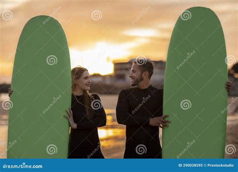 Portrait Of Romantic Young Man And Woman With Surfboards Posing On