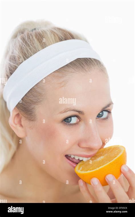 Woman Biting Slice Of Orange Stock Photo Alamy