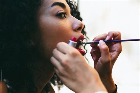 Makeup Artist Applying Lipstick