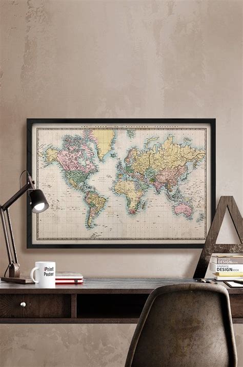 a desk with a chair and a framed map on the wall