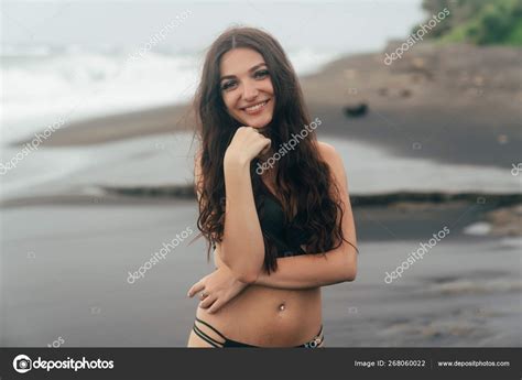 Sexy Smiling Brunette Girl In Swimsuit Posing On Black Sand Beach Stock Photo Rmano Mail Ru