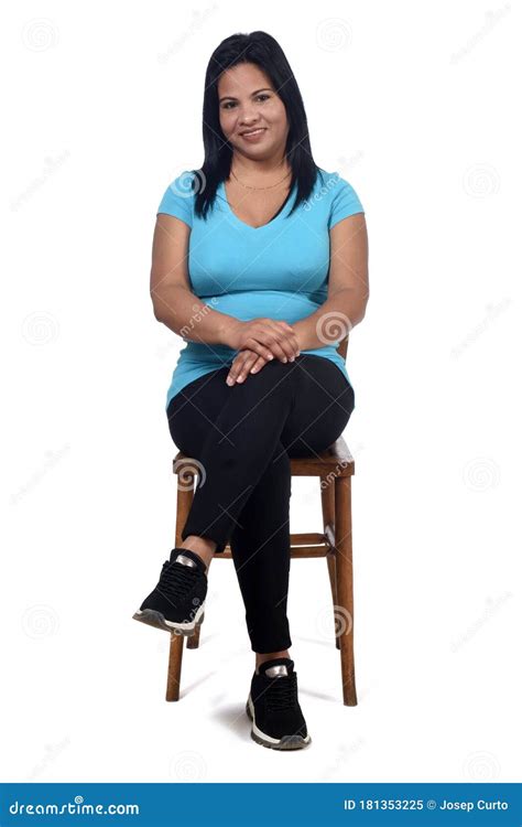 Portrait Of A Woman Sitting On A Chair In White Background Front View