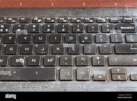 Close Up On Dirty And Unhygienic Computer Laptop Keyboard Full Of Dust