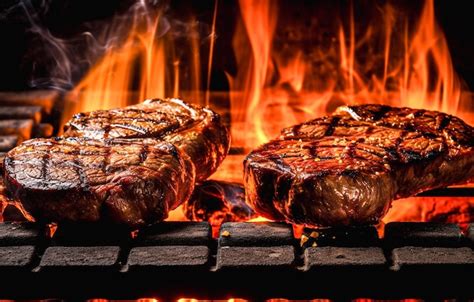 Grilled Beef Steaks On The Grill With Flames And Smoke Premium Ai