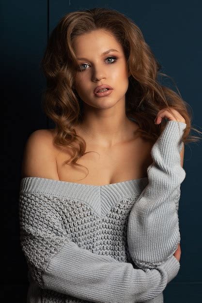 Premium Photo Seductive Blonde Woman With Curly Hair Wearing Knitted