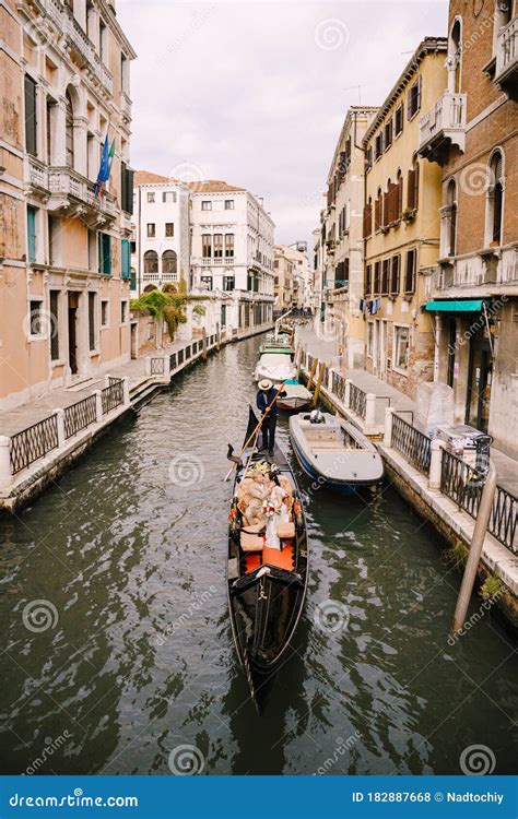 Italy Wedding In Venice A Gondolier Rolls A Bride And Groom In A