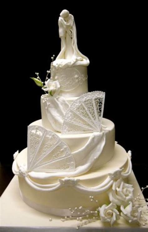 Ivory And White Wedding Cake With Royal Icing Fans And Roses