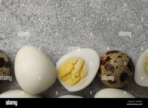 Peeled And Unpeeled Hard Boiled Quail Eggs On Grey Table Flat Lay