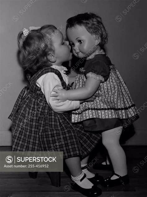 Girl Kissing Doll Superstock