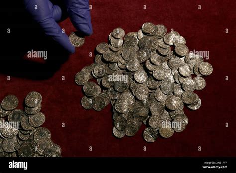 A Curator Positions A Coin For A Picture With Some Of The Other