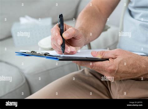 Man Writing On Notepad Stock Photo Alamy