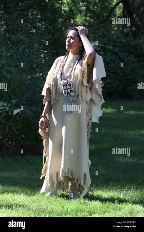 A Native American Indian Lakota Sioux woman standing in a leather dress Stock Photo - Alamy