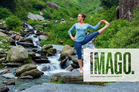 Woman Doing Ashtanga Vinyasa Yoga Asana Outdoors At Waterfall Yoga