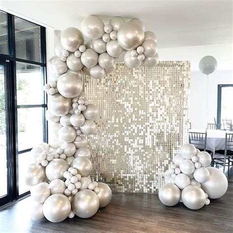 Balloons Are Arranged In The Shape Of An Arch With White And Silver