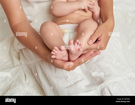 Baby Legs In Mother Hands On White Background Stock Photo Alamy