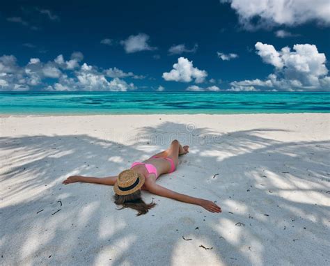 Woman In Bikini At Tropical Beach Under The Palm Tree Stock Photo