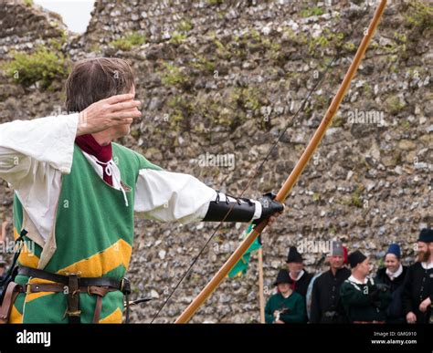 A Medieval Reenactor Displays Longbow Archery Techniques Within The