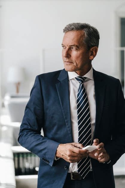 Premium Photo Portrait Of Mature Businessman With Cell Phone