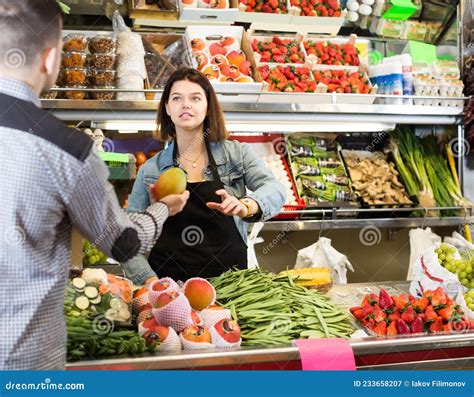 Female Seller Assisting Customer To Buy Fruit And Vegetables In Grocery Shop Stock Image Image