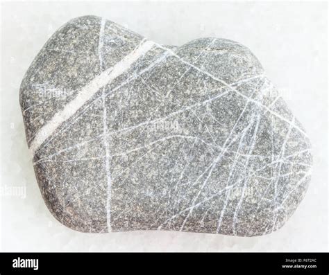 Pebble Of Greywacke Sandstone On White Marble Stock Photo Alamy