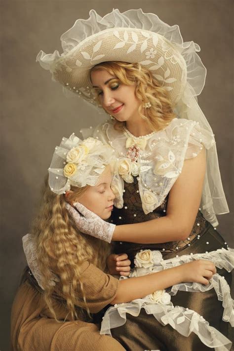 Mother And Daughter Vintage Mother Sitting And Looking Down On Her