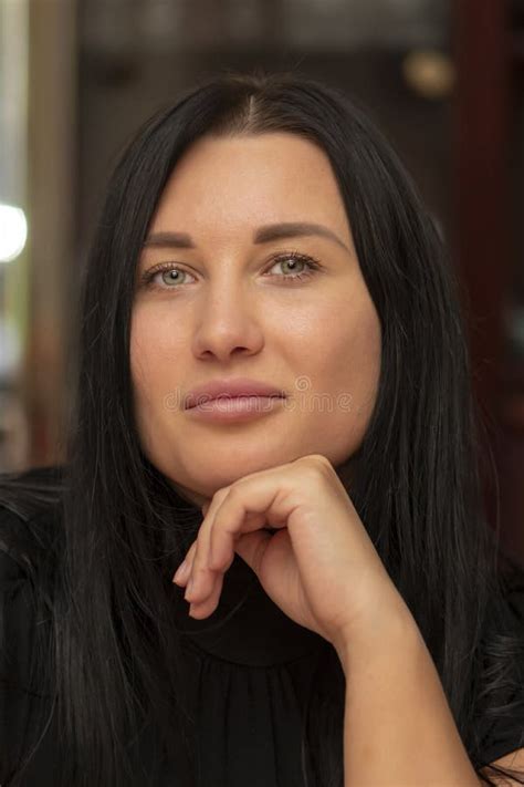 Portrait Of A Beautiful 30 Year Old Woman With Long Hair Indoors Close