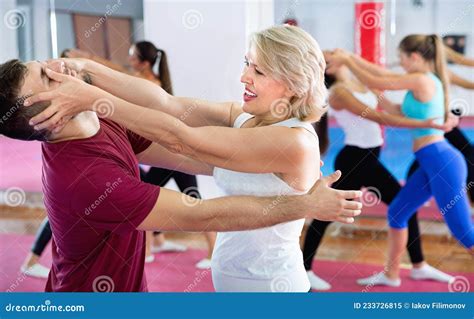 Sporty Mature Woman With Her Instructor Are Training Self Defence Moves