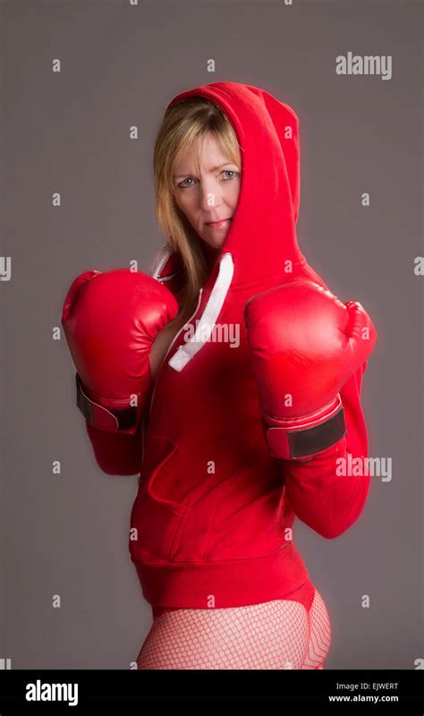 Woman Fighting Fit And Wearing Red Boxing Gloves And Jacket Stock Photo