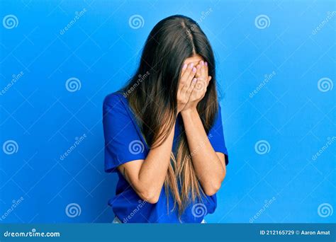 Young Hispanic Woman Wearing Casual Clothes With Sad Expression