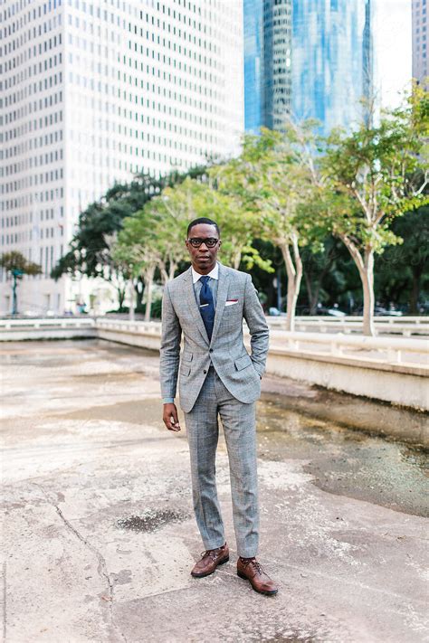 Guy In A Suit Standing By Office Buildings By Stocksy Contributor