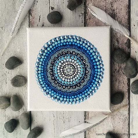 A Blue And White Painting Sitting On Top Of A Wooden Table Next To