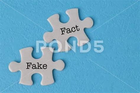 Jigsaw Puzzle With Text FACT And FAKE Isolated On A Blue Background