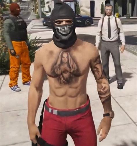 A Man With No Shirt On Wearing Red Shorts And A Black Mask Is Walking