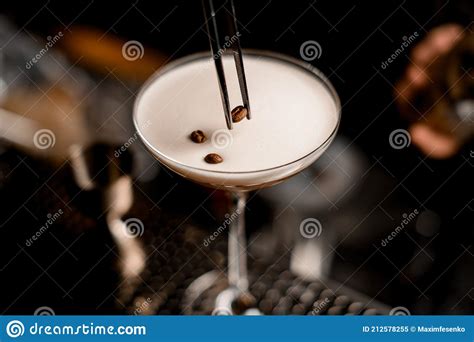 Close Up Of Glass With Frothy Espresso Martini Cocktail Decorated With