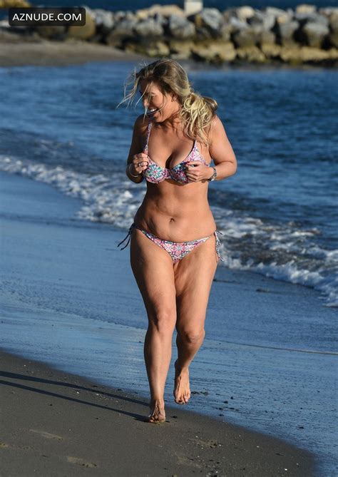 Frankie Essex Jogs On The Beaches Of Tenerife With Her Multicolored Skimpy Bikini On Her