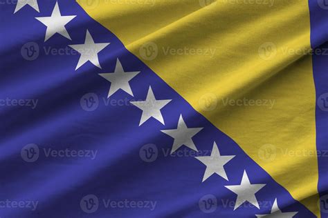 Bosnia and Herzegovina flag with big folds waving close up under the ...