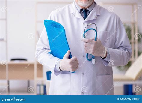 Old Male Doctor Working In The Clinic Stock Photo Image Of